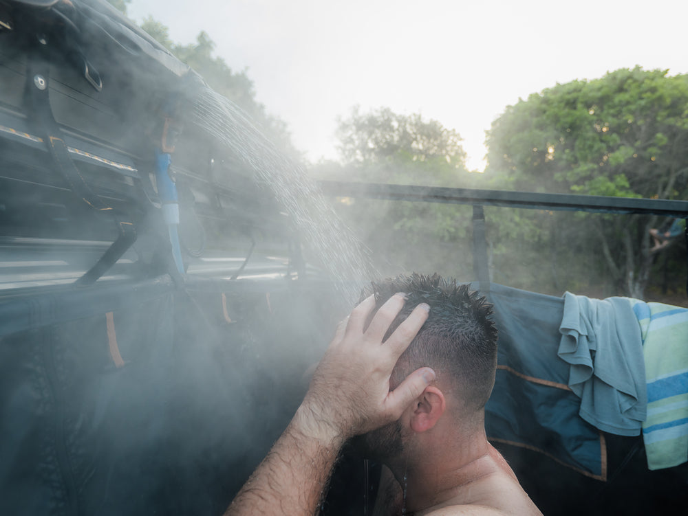 A Man Having A Hot Shower Using The Kakadu Outback Shower