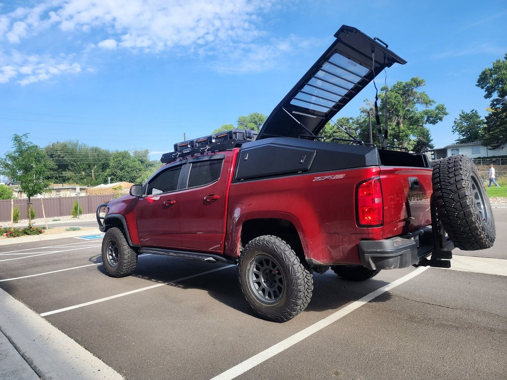 Side View Of The Installed GAIA Campers Tacoma Shadow Top Truck Cap With Opened Pop Top Lid