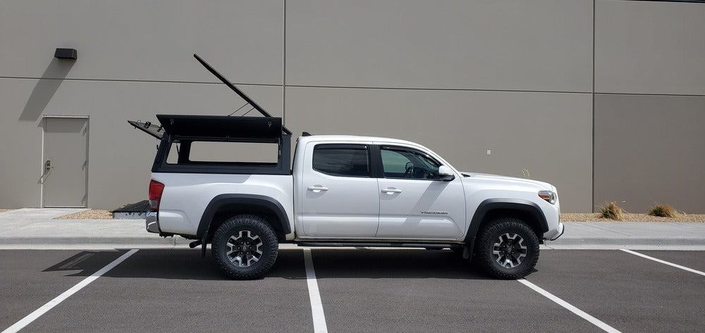 Side View Of The Installed GAIA Campers Tacoma Truck Cap With All Door And The Pop Top Opened