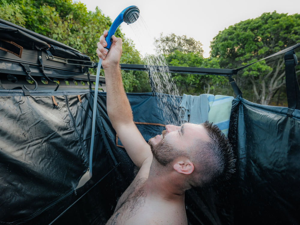 A Man Washing His Face With A Kakadu Outback Shower