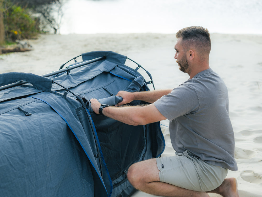 Person Folding Up The Canvas Window On The Kakadu Sundowner Swag Tent