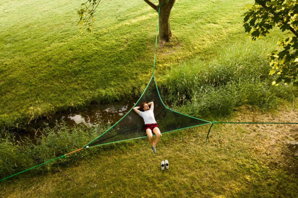Top View Of A Person Lounging On A Tentsile T-Mini Green 2 Person Camping Hammock