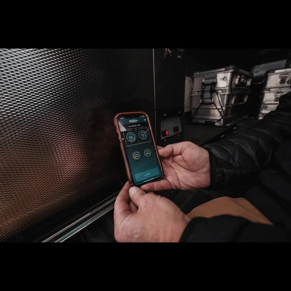 Man using the NL app to control the temperature of the fridge