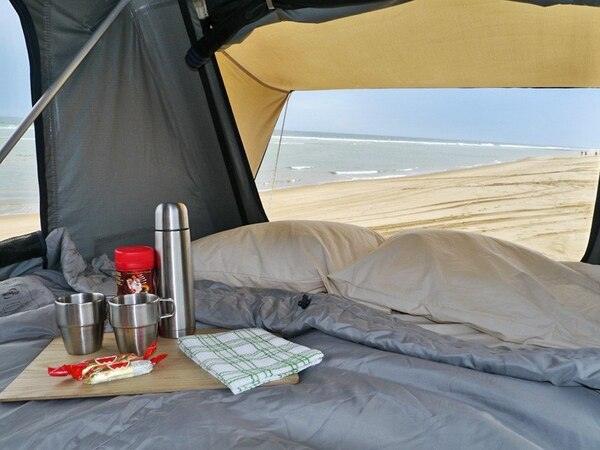 Inside Of The Front Runner Roof Top Tent Showing Camping Cups And A Coffee Container