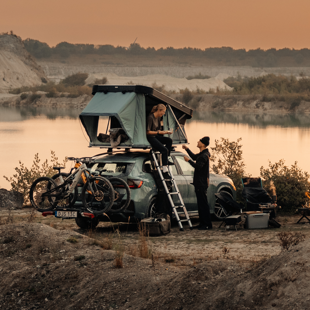Thule Widesky rooftop tent mounted on SUV with bike rack at campsite
