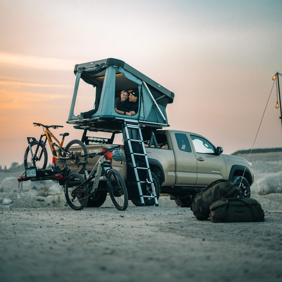 Thule Widesky hardshell tent open with two people inside at camp