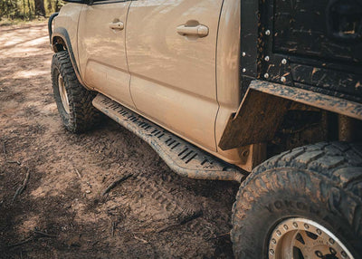 Backwoods Adventure Mods 2005-2023 2nd and 3rd Gen Toyota Tacoma Rock Sliders being used while off roading