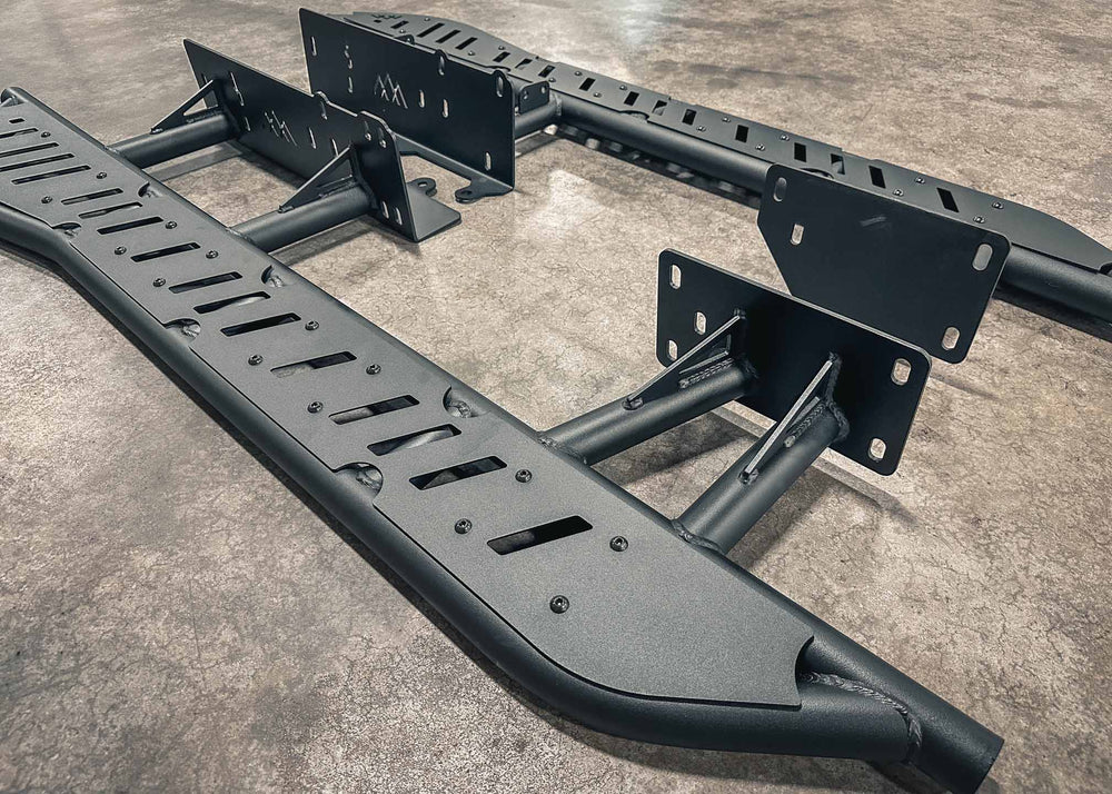 Close up image of the heavy-duty gusseted frame mounts and bolt-on top plates of the Backwoods Adventure Mods 2010-2024 5th Gen Toyota 4Runner Rock Sliders