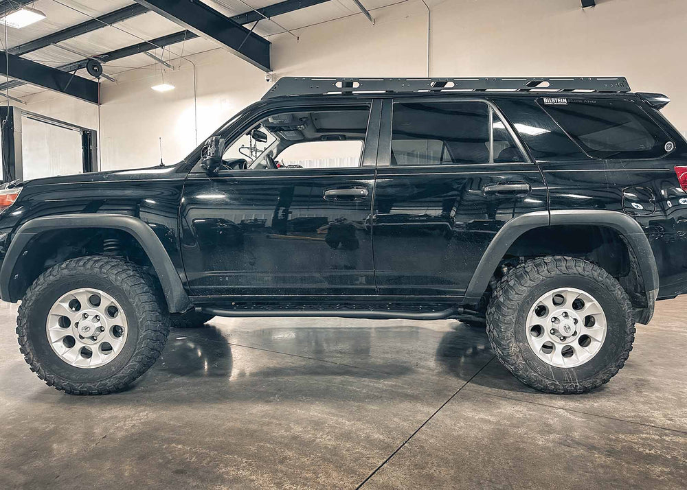 Backwoods Adventure Mods 2010-2024 5th Gen Toyota 4Runner Rock Sliders installed on a black 5th gen 4runner