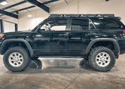 Backwoods Adventure Mods 2010-2024 5th Gen Toyota 4Runner Rock Sliders installed on a black 5th gen 4runner