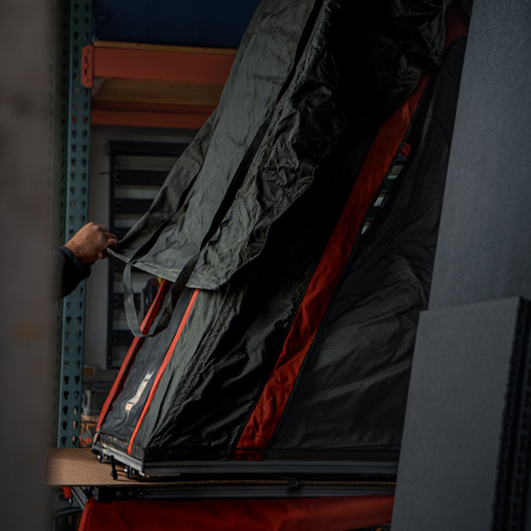 Image showing a man using the zippers of the badass packout tent