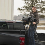 A Person Setting Up The Toyota Fas-Top Solo Soft Truck Topper