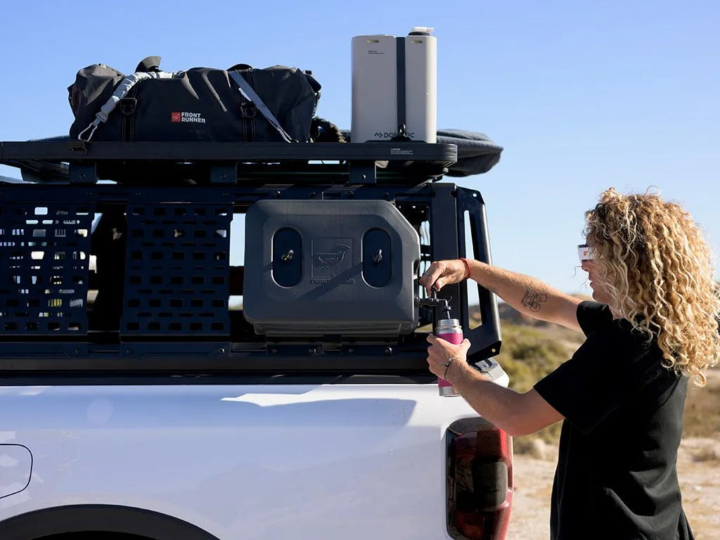 Image showing a woman using  the pro bed water kit without the water tank to pour water 