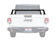 White Jeep truck with a black roof rack on a white background