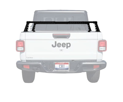 White Jeep truck with a black roof rack on a white background
