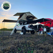 OVS HD Nomadic 90 degree truck awning deployed on vehicle in field
