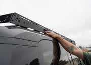 Person using grab handle on DRIFTR GX550 roof rack
