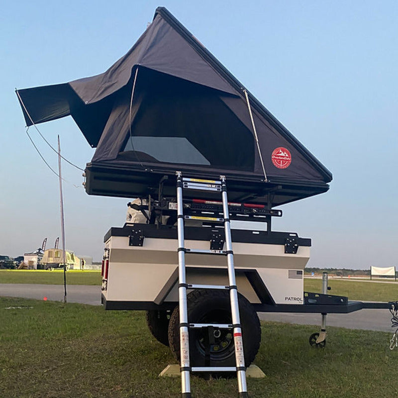 Rustic Mountain Overland Patrol XC off-road trailer with black clamshell rooftop tent mounted on top