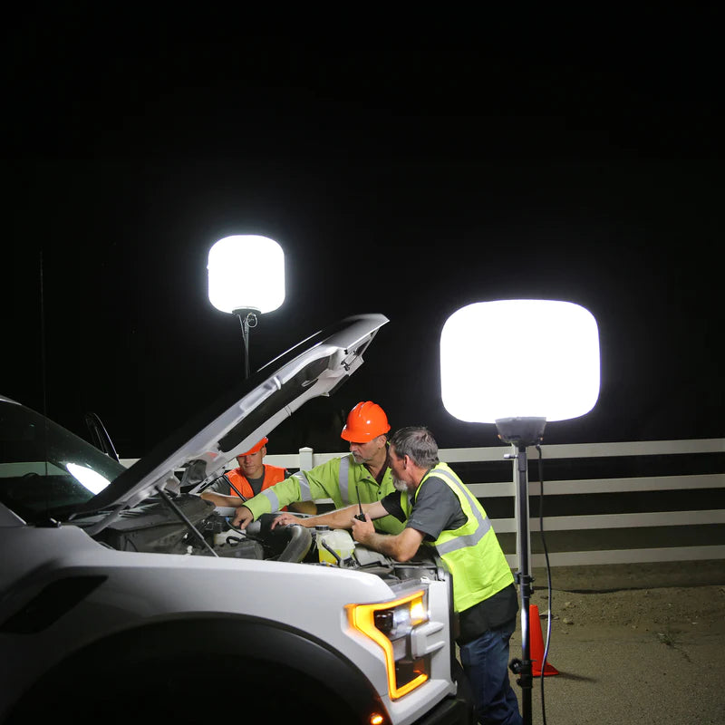 Image showing three people fixing a car using two see devil 250 watt ballon light kits