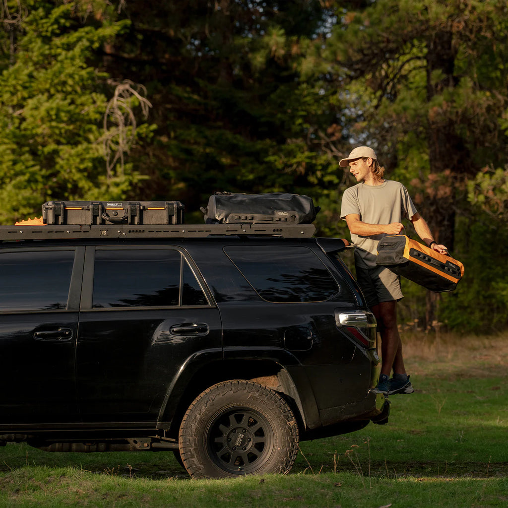 Image of a man adding camping equipment on the raconteur roof rack