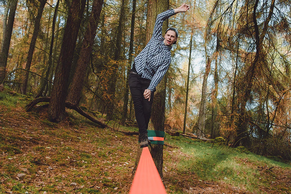 Image of a man having fun while using the tentsile slackline