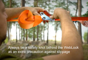Man tying a safety knot behind the weblock