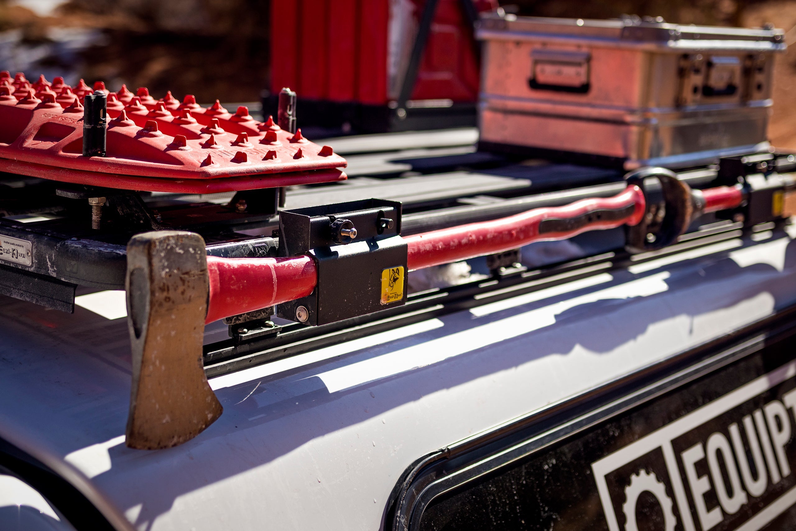 Eezi-Awn K9 roof rack with accessories mounted including recovery gear storage cases and expedition equipment