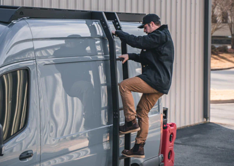 Man Climbing Up The Backwoods DRIFTR Sprinter Ladder