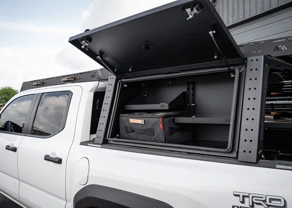 Backwoods Toyota Tacoma Overland Bed Rack cargo box open showing interior