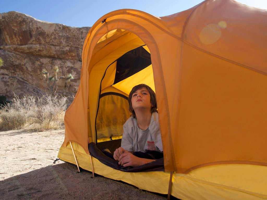 child inside the desert colored C6 Rev Roof Top Tent X