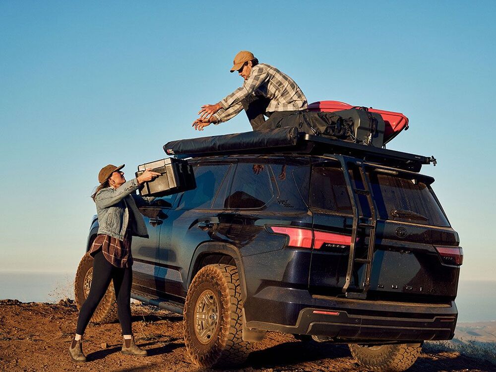 People Mounting Gear On A Front Runner Slimline II Toyota Sequoia Roof Rack