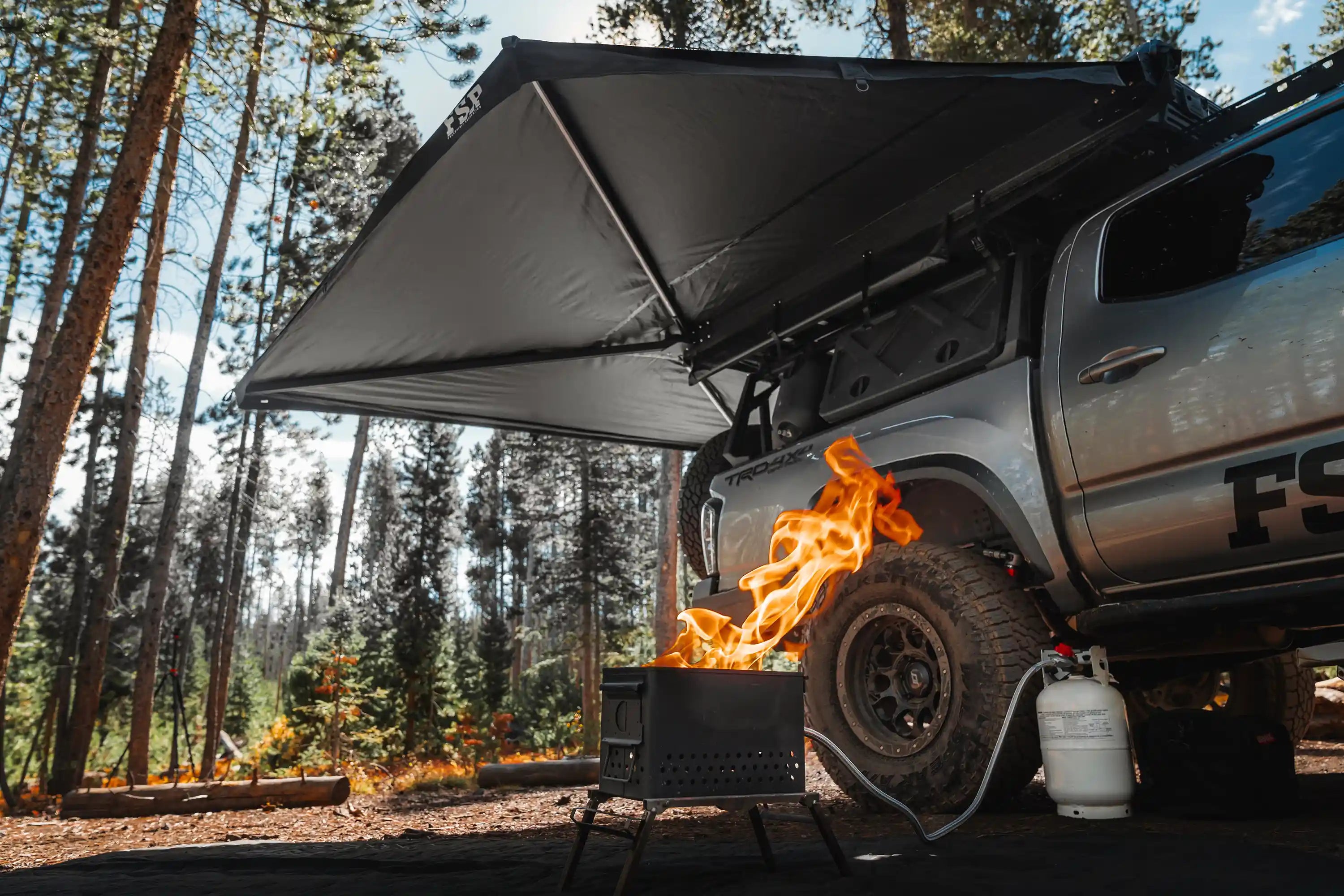 Freespirit Recreation 270 Awning V2 deployed over a camp setup providing wraparound shade