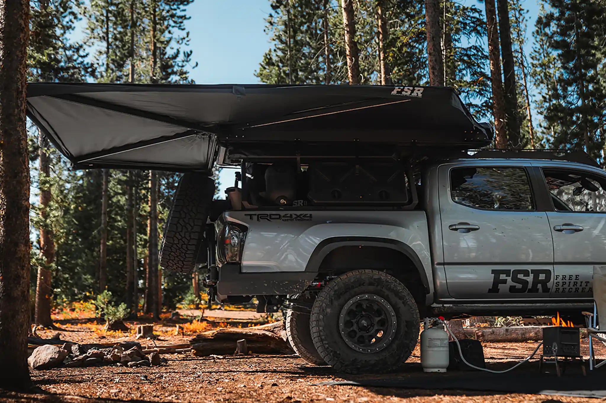 FSR 270 Awning V2 deployed on a vehicle showing side and rear wraparound coverage at camp