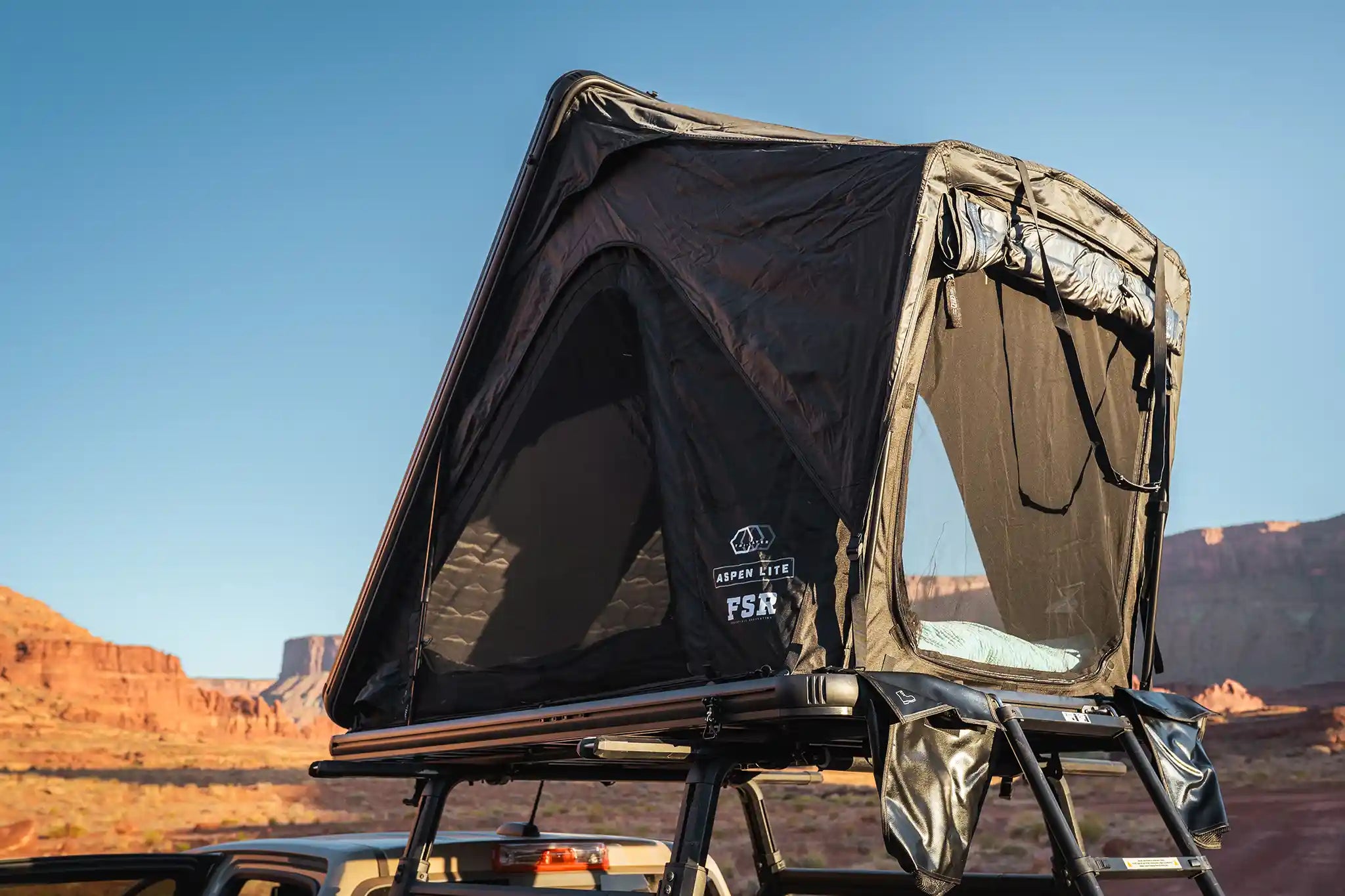 Freespirit Recreation Aspen Lite Standard V3 clamshell rooftop tent mounted and in use