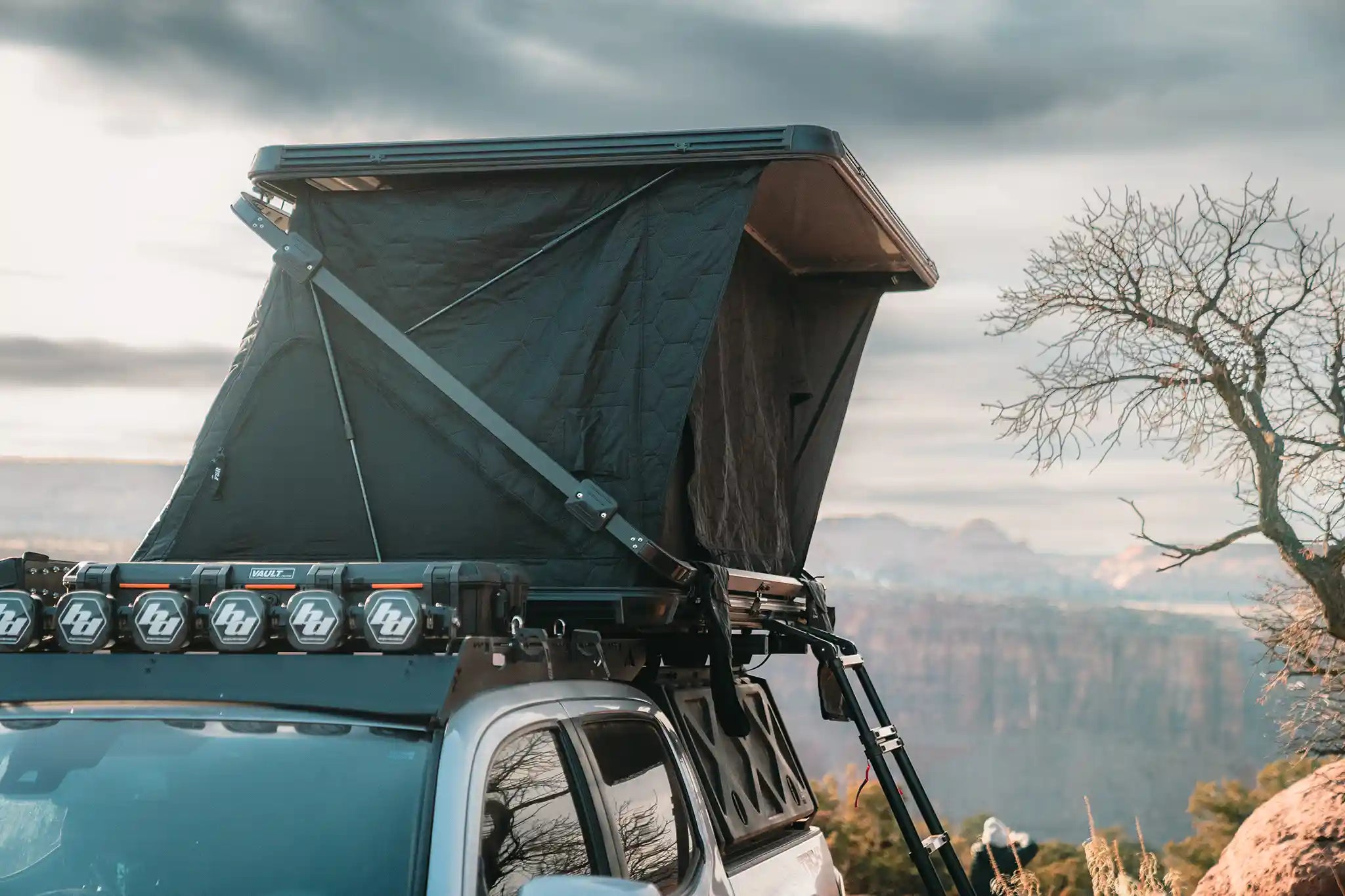 Freespirit Recreation Evolution XL side-opening hard shell rooftop tent set up at camp