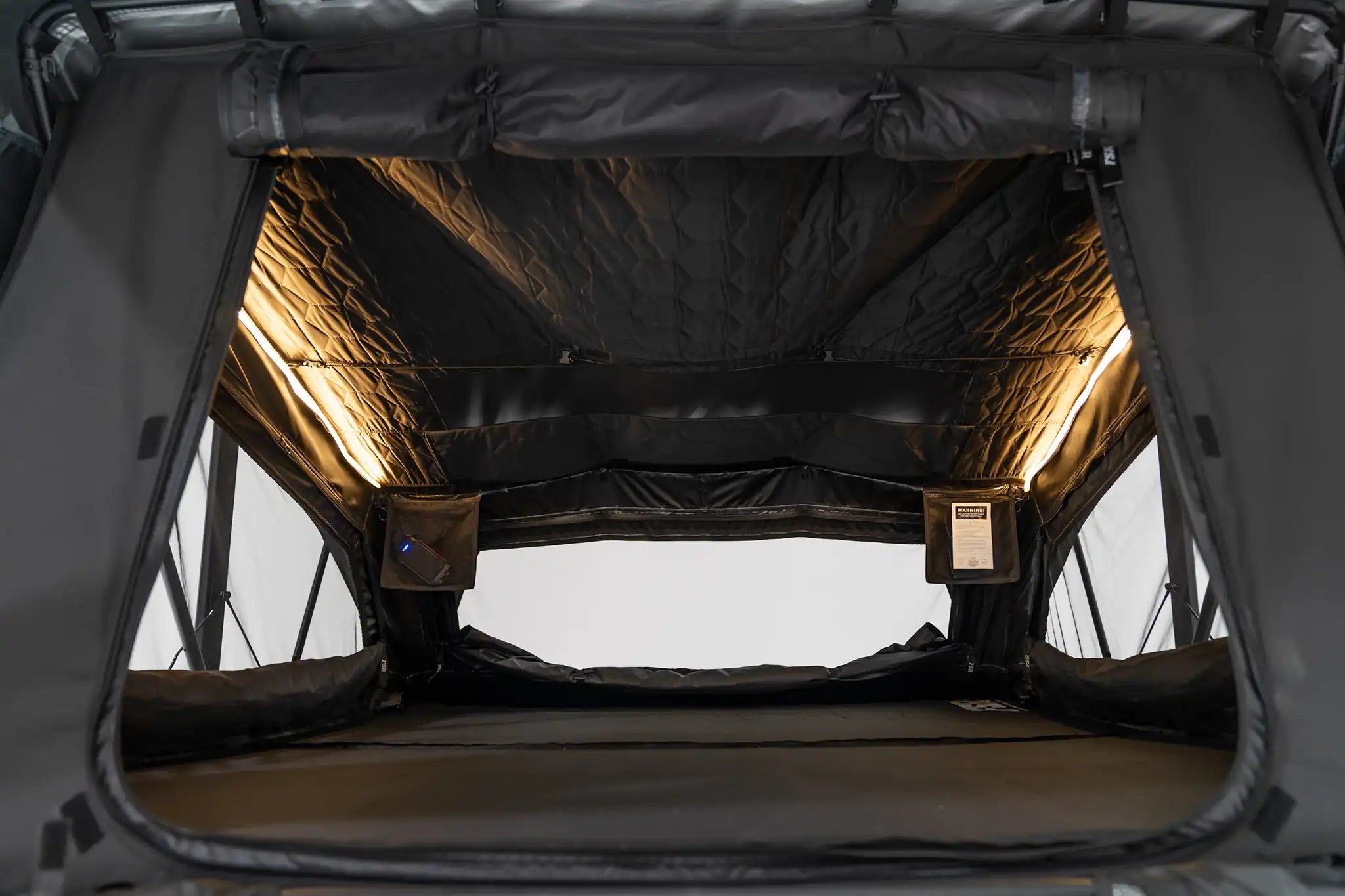FSR Nova King rooftop tent interior showing integrated dimmable LED lighting and storage pouches