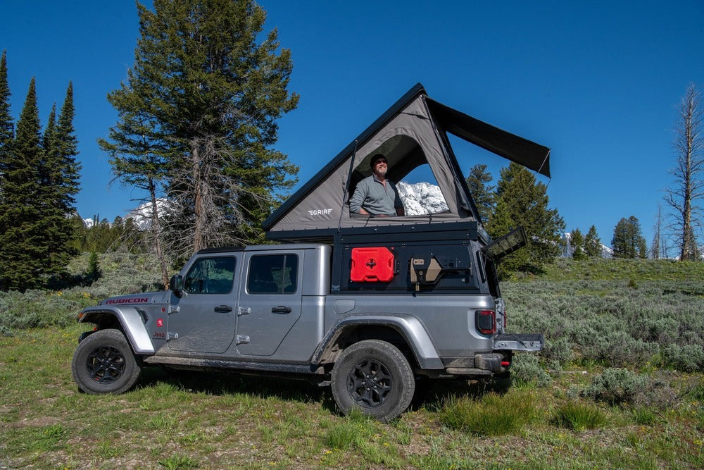A Person Standing Inside The Deployed GAIA Campers Jeep Gladiator Camper