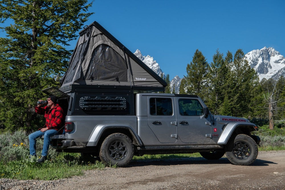 Person Sitting On The Tailgate Of the Jeep Gladiator With The GAIA Campers Camper Installed