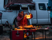 Image showing a man using the ikamper light stand to attach a lantern