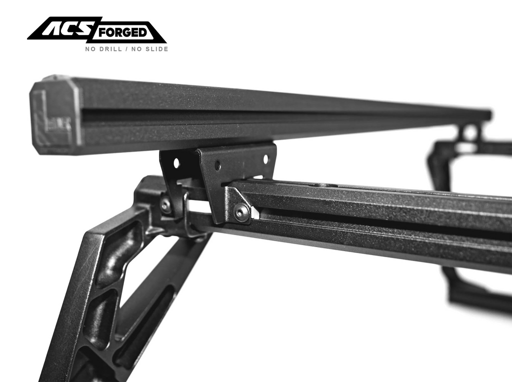 Detailed view of the upper mounting assembly of the ACS Forged rack, showing the T-slot load bar attached to the forged upright with black Grade 10.9 hardware.