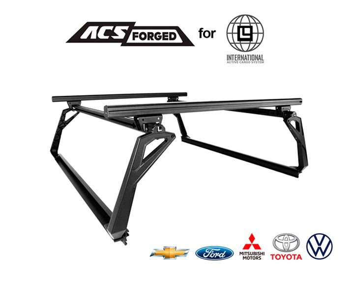 Product hero shot of the ACS Forged bed rack for international trucks, featuring the Leitner Designs logo and automotive brand logos including Toyota, Ford, and Chevrolet.