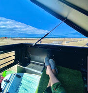A Person Sitting Inside The GAIA Campers Truck Cap Installed On The 3rd Gen Tacoma