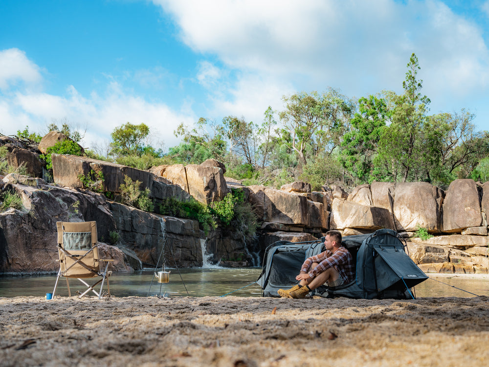 Person Sitting On One Of The Openings Of The Kakadu Sundowner Swag Tent