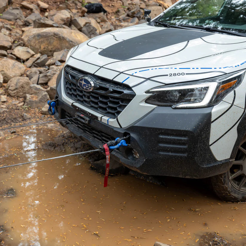 Image showing the Subaru Outback Wilderness getting pulled out of the mud using the rallitek hidden winch bumper