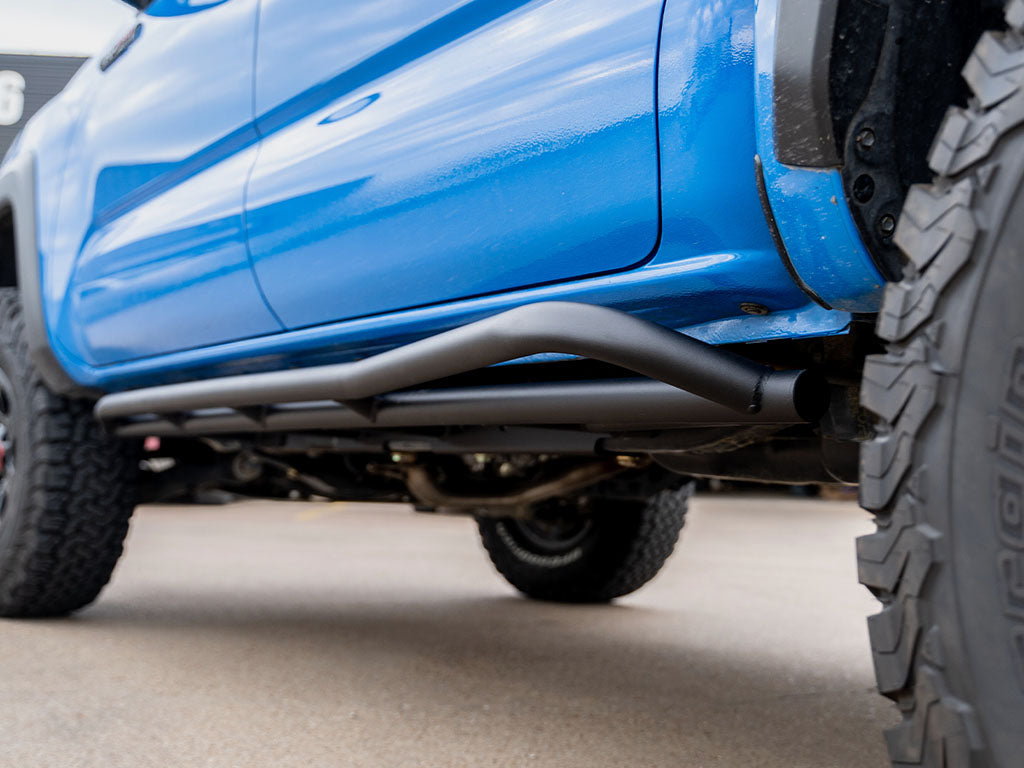 Cali Raised Trail Edition rock sliders installed on 2005-2023 Toyota Tacoma showing angled trail profile