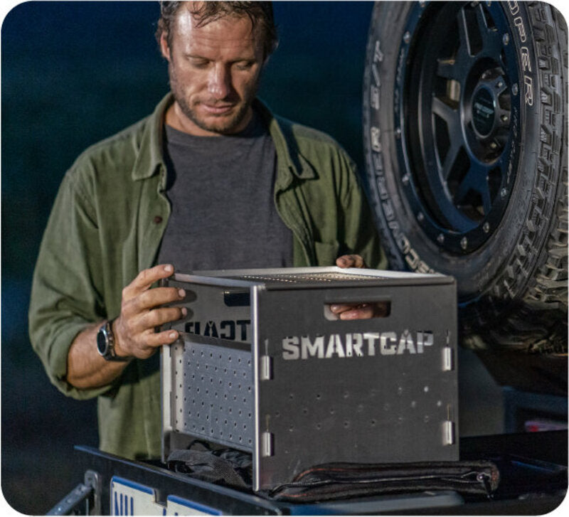 A Person Assembling A RSI SmartCap Flame BBQ/Fire Pit