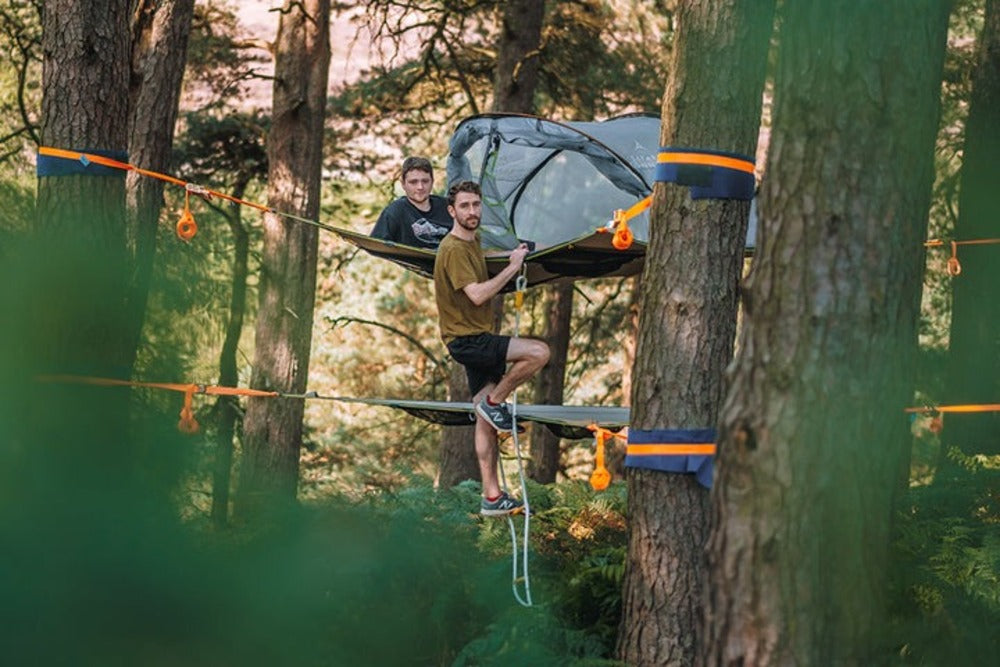 A Person Climbing On A Tentsile Safari Ladder