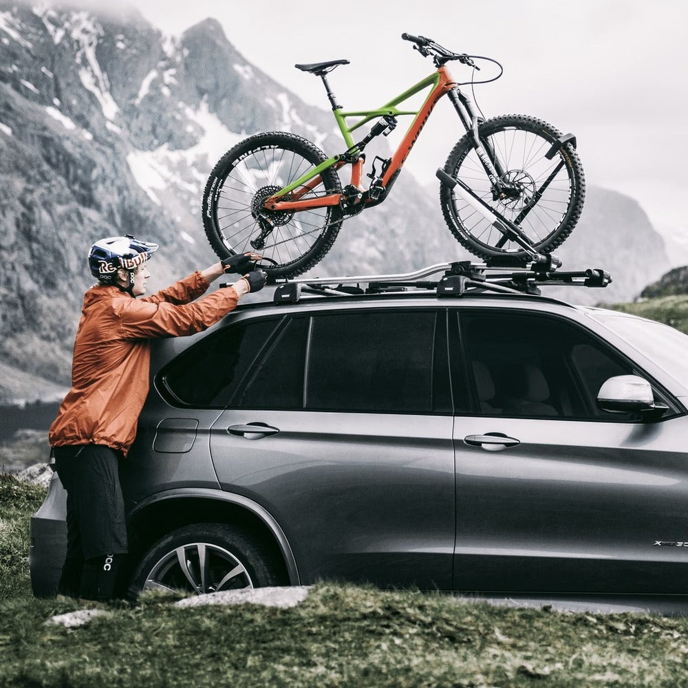 Person Mounting A Bike On The Thule UpRide Bike Rack