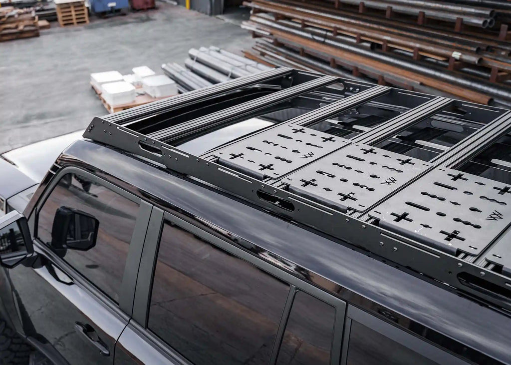 Top of Backwoods DRIFTR LC250 roof rack showing extrusion mounting system