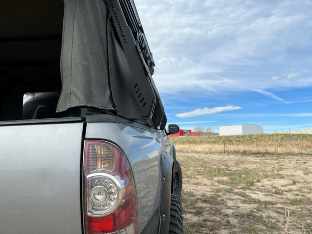 Back Side Of The Mounted upTOP Overland Tacoma Soft Top Compatible TRUSS Bed Rack